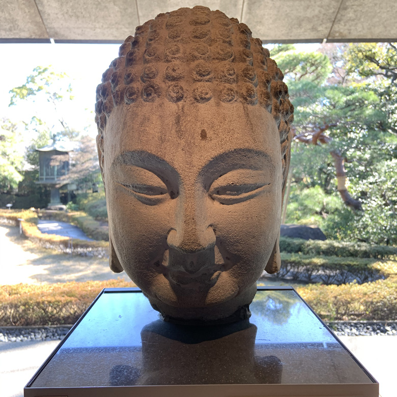 Stone Buddha in Nezu Gardens, Japan.