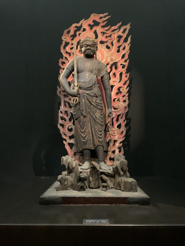 A photograph of a statue of the Wisdom King Fudo, a statue of a monk from the 11th century in the Tokyo National Museum in Japan. Photographed by Rebecca Newnham.