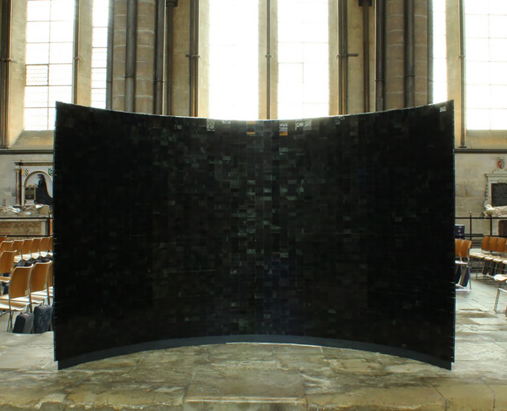 Another of two large, black enameled glass sculptures by Rebecca Newnham called Sound Parabolas in Salisbury Cathedral. Photographed by David Bird.